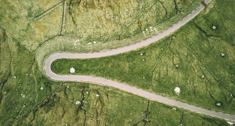 an aerial view of a winding road in the countryside